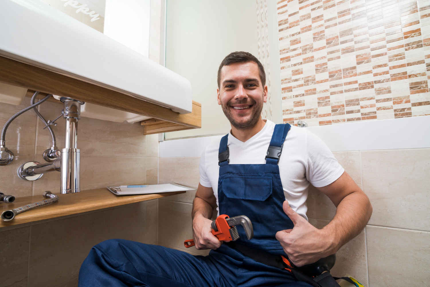 Plumber unblocking drain